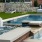 a pool with a bench and a chair by it